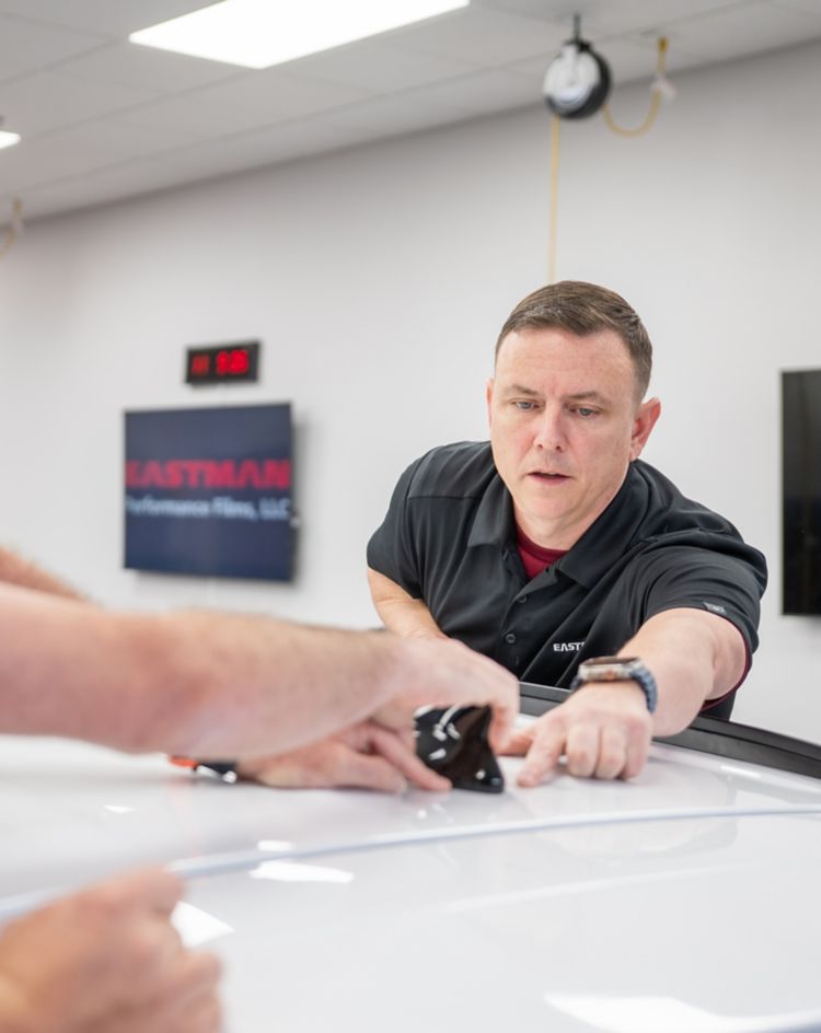 Two men installing paint protection film 