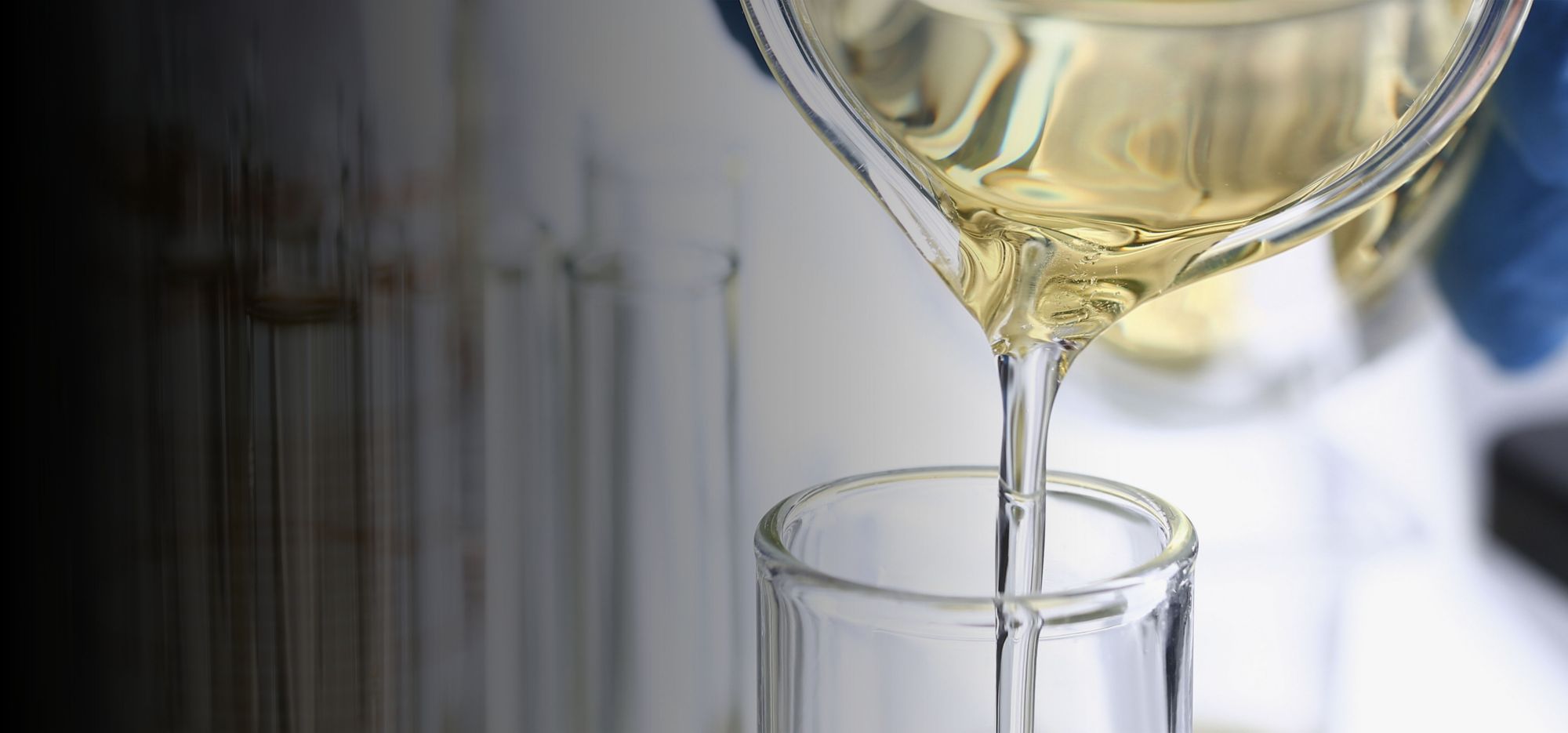  A person in a green gown poses. It looks as if plastic waste is flowing into the fabric of the garment.  