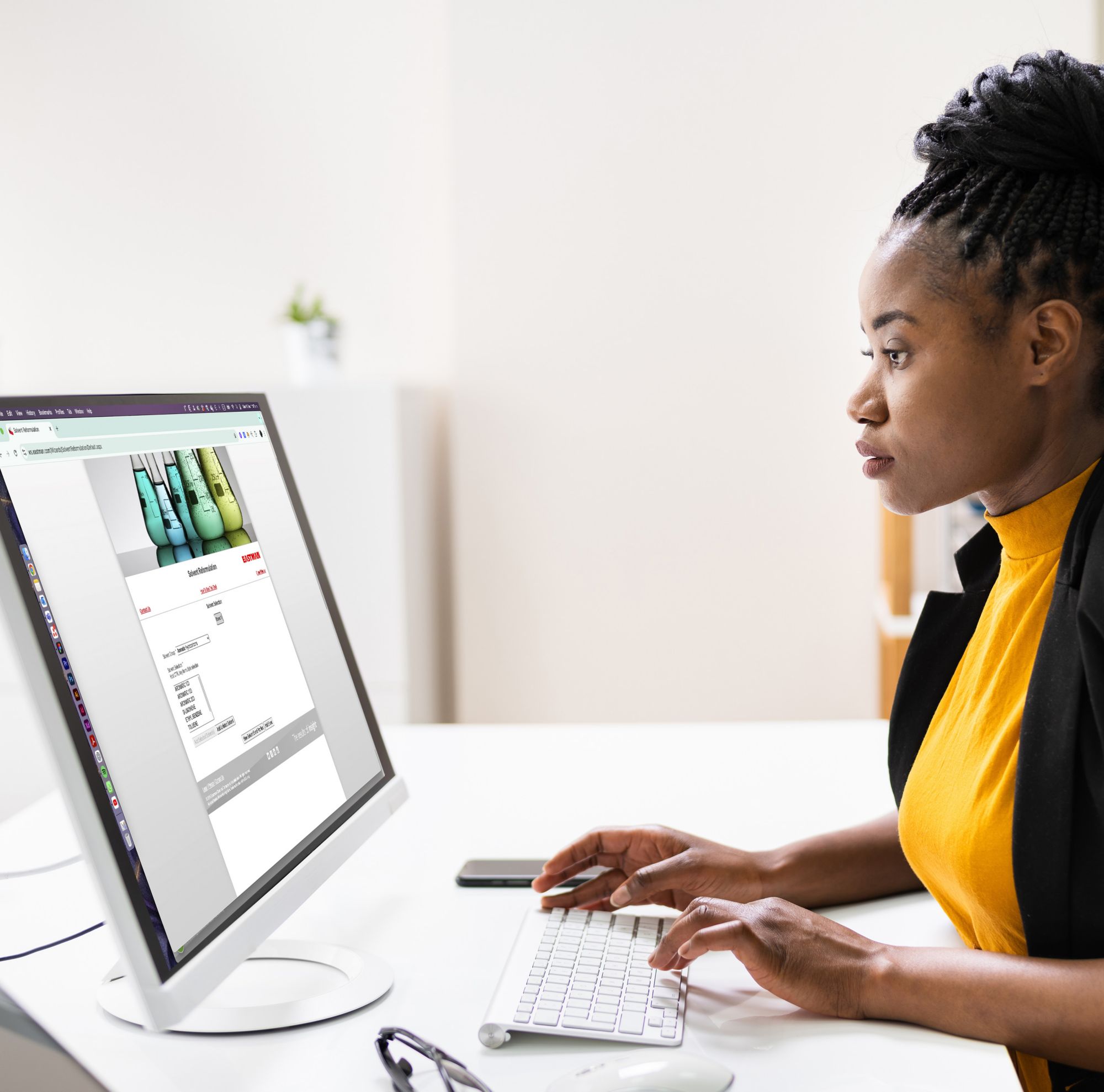A woman types on a computer. 