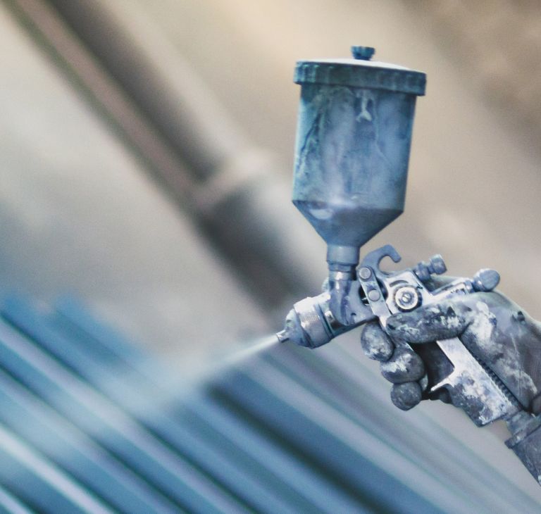 Painting with an aerosol hand sprayer. 