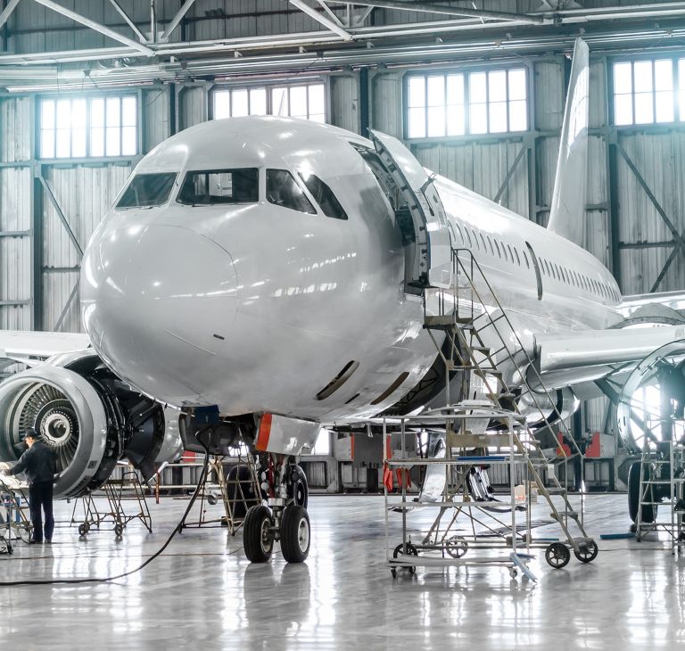 An airplane in a hangar. 