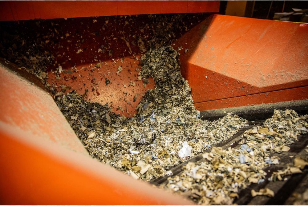 Shreds of apparel waste on a conveyor belt 