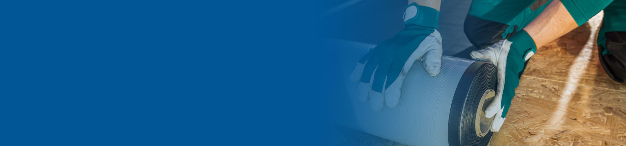 Blue banner fade over a picture of roofing worker preparing a roll of EPDM roof membrane material. 