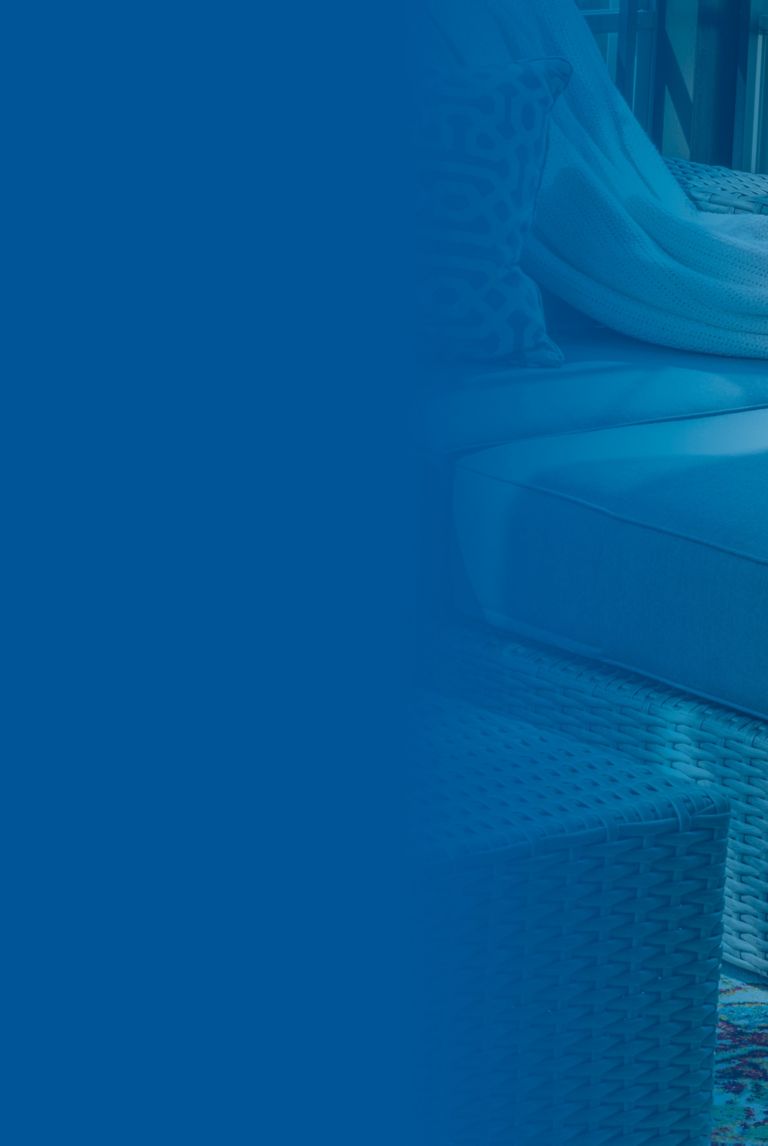 Blue banner fade over a picture of  a close up of patio furniture in modern screened porch. 