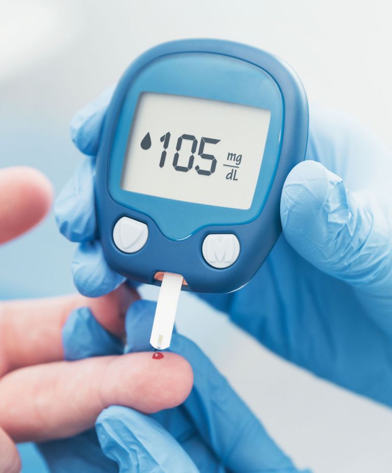 A patient getting their blood drawn with a blood glucose monitor 
