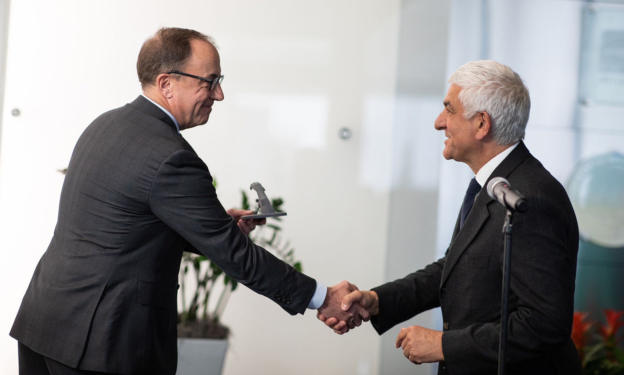 Eastman Executive Vice President, Brad Lich, shakes hands with France President, Herve Morin.  