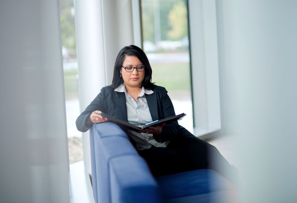 Employee reviewing invoice inquiry documents. 