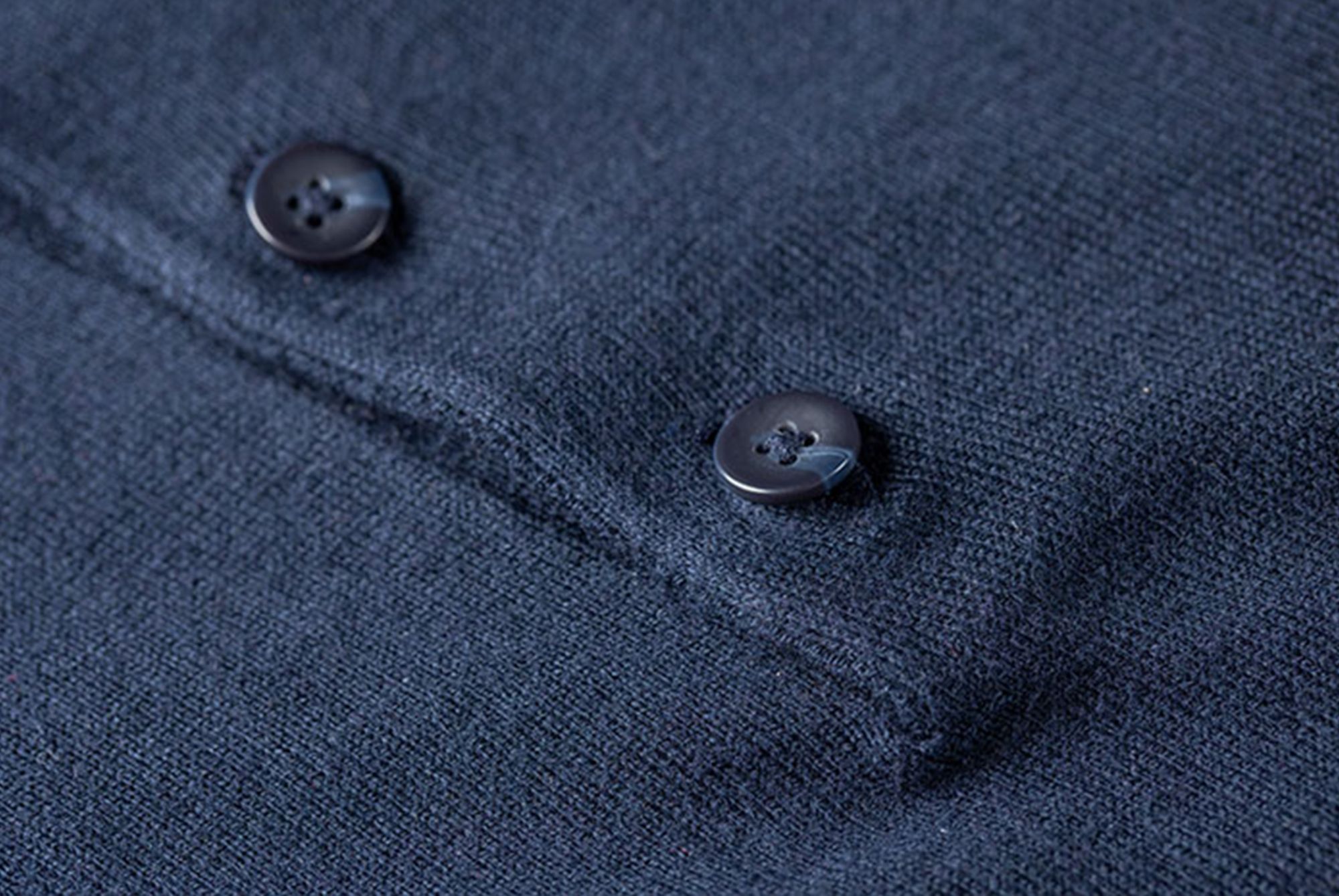 Close up of blue polo shirt made with sustainable materials 