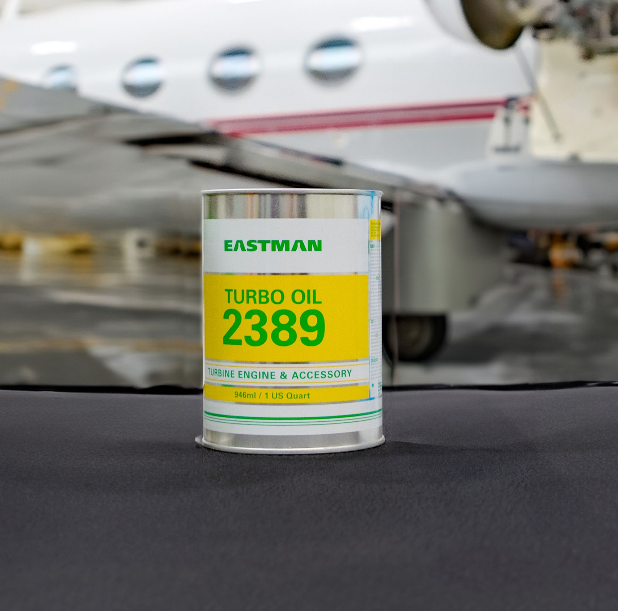 A can of turbo oil sits in front of a plane. 