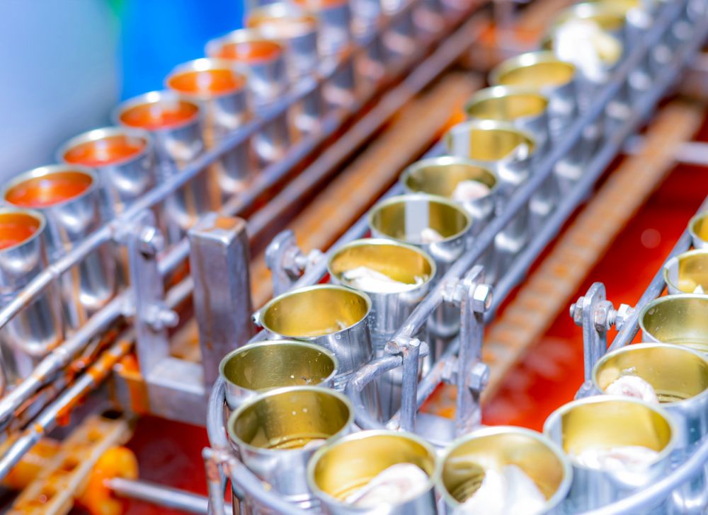 A factory line of cans ready to be filled with beans. 