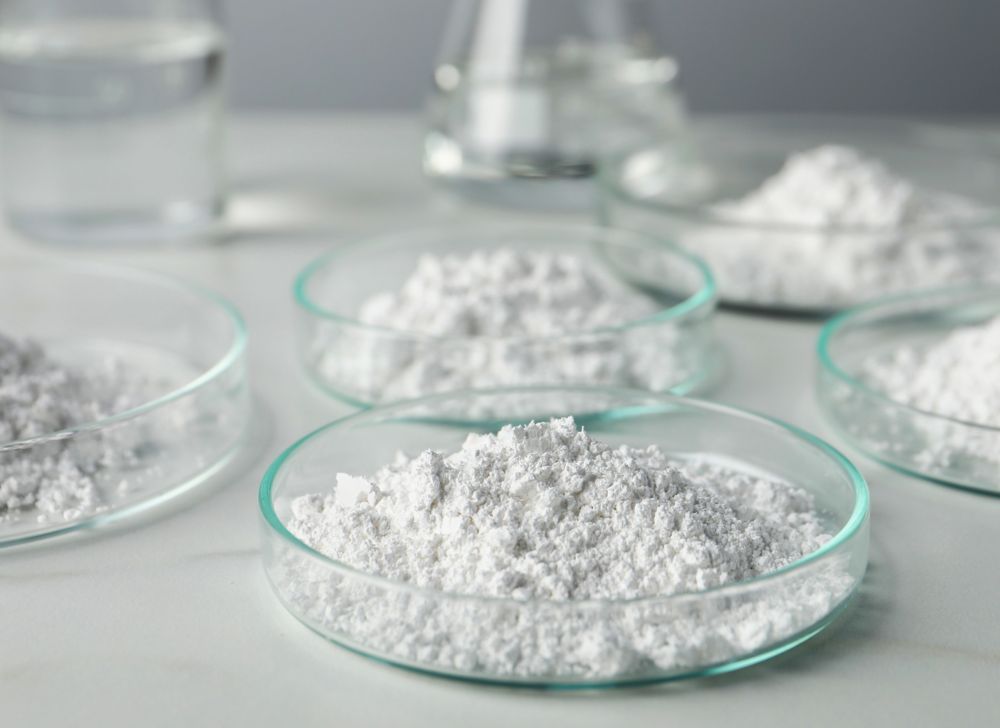 Five petri dishes containing white powder. 