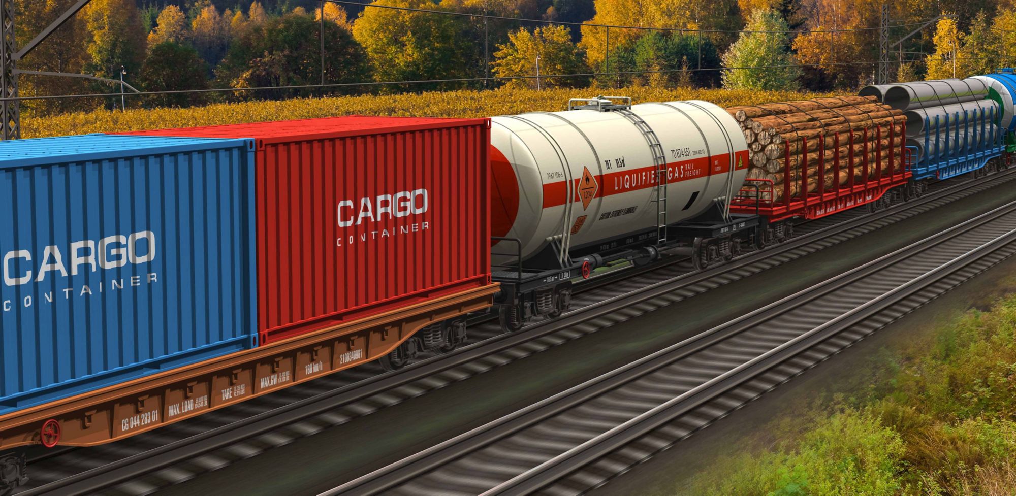 A train travels on a track near a forest with multicolored fall leaves.  