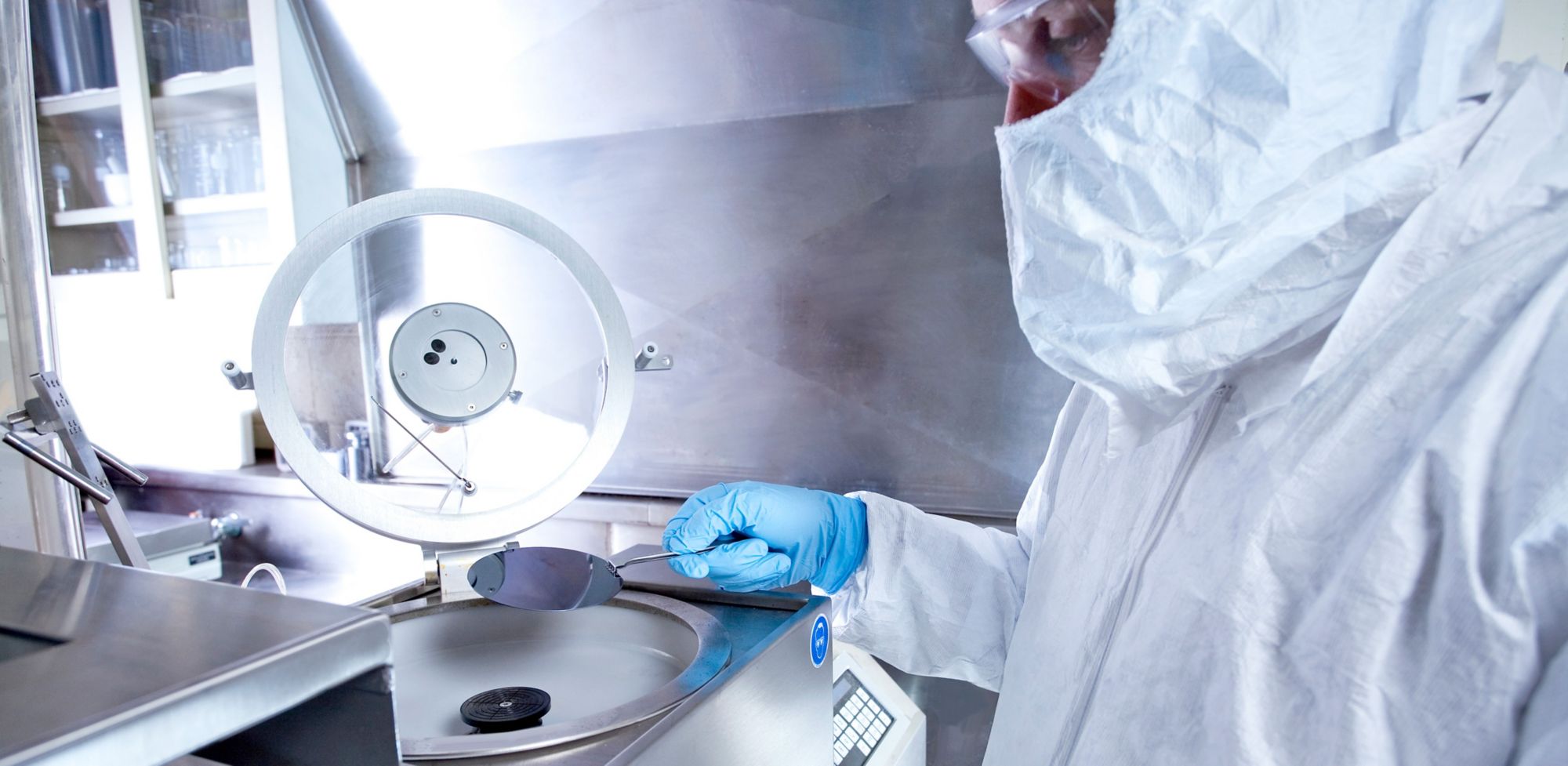 A scientist examines liquid through a magnifying glass 