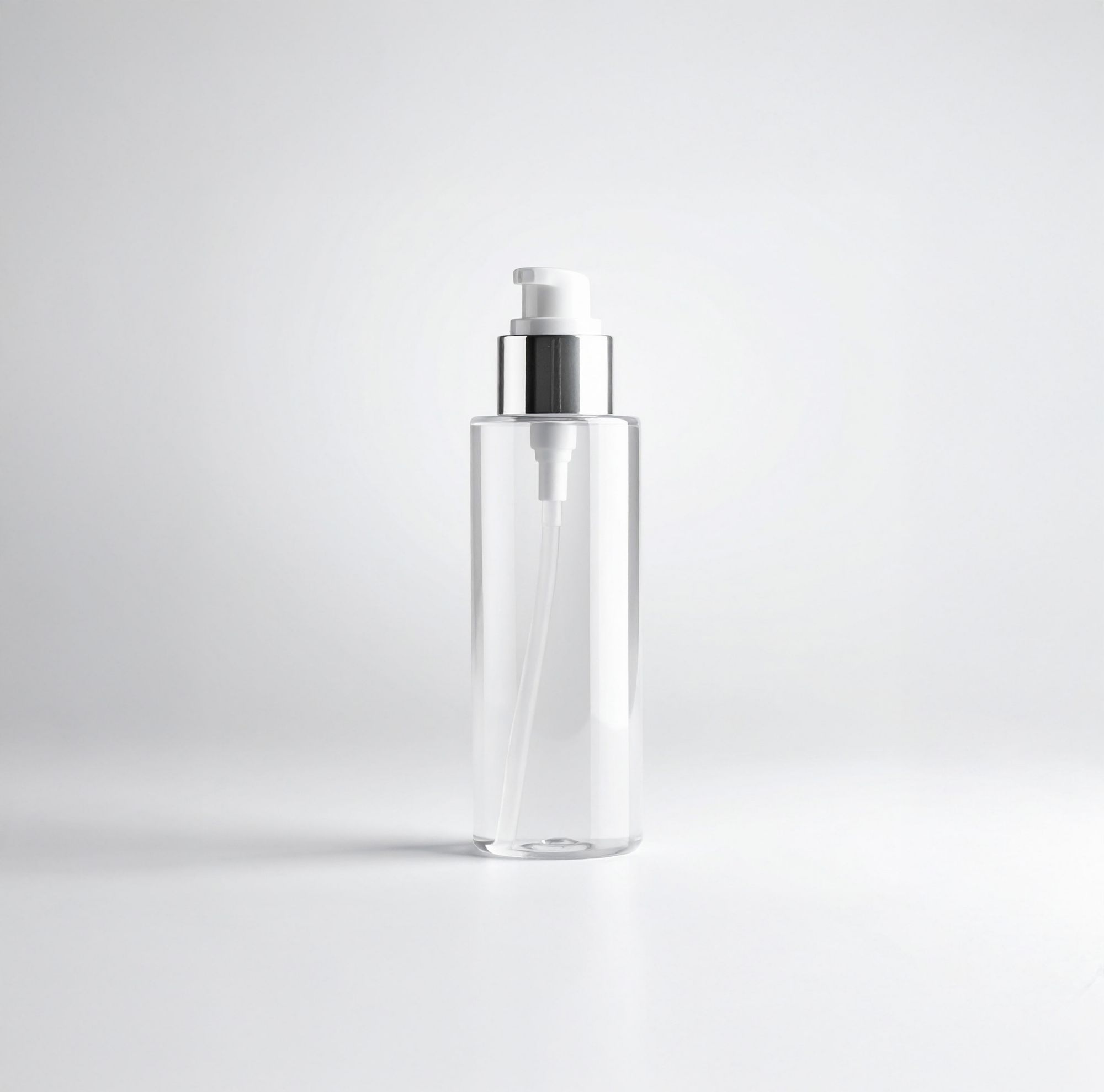 A clear pump bottle set in front of a white background. 