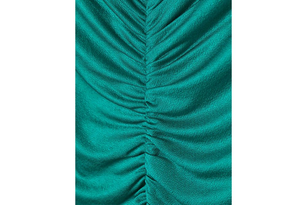 Close up of H&M brand emerald green dress made of 91% cellulose acetate Eastman Naia™. 