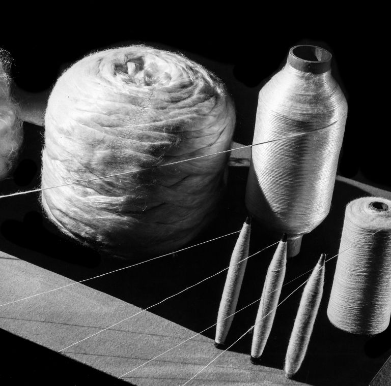 Fibers are spun onto spools. 