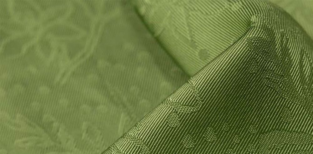 Closeup green satin patterned cloth 