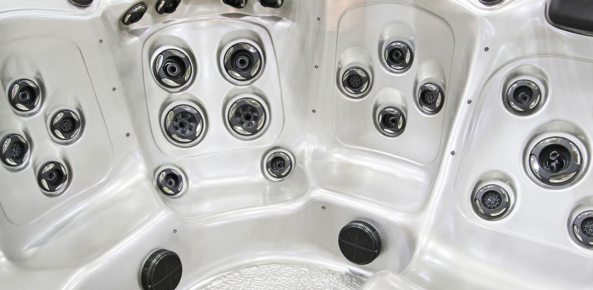 The inside of an empty hot tub is shown. 