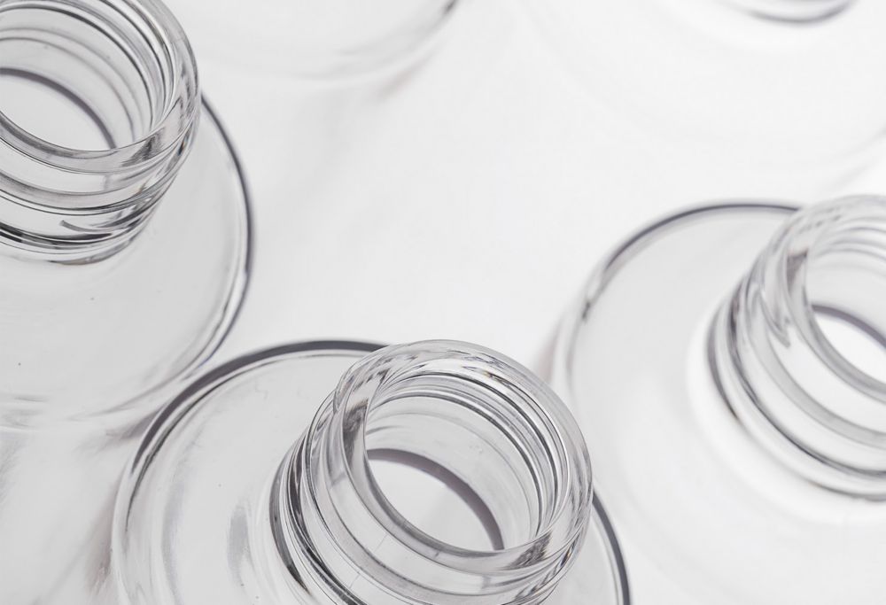 Close-up of three clear, screw-top bottles 