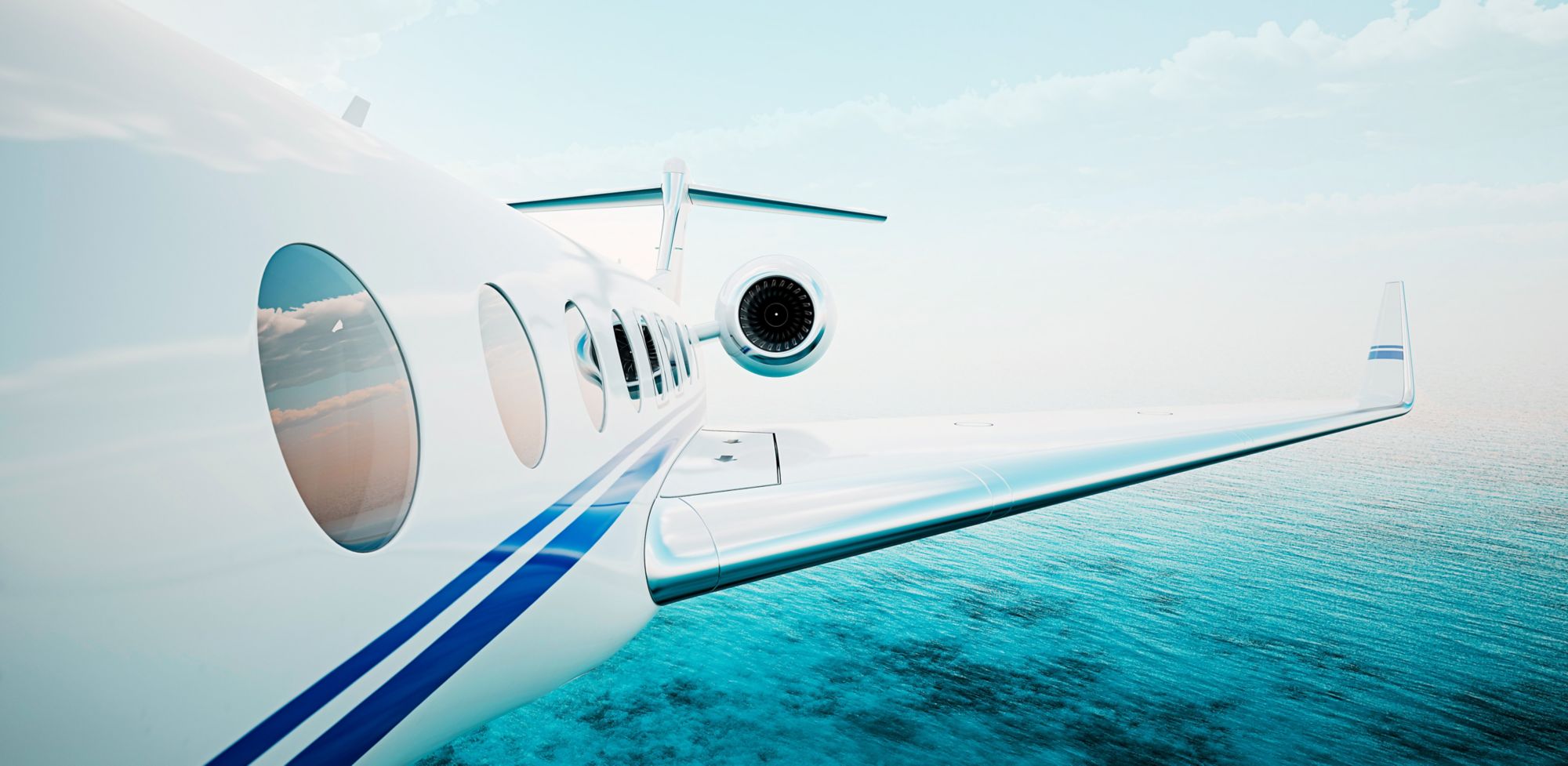 The exterior of a white plane that’s flying is seen from the front of the plane’s left side. 