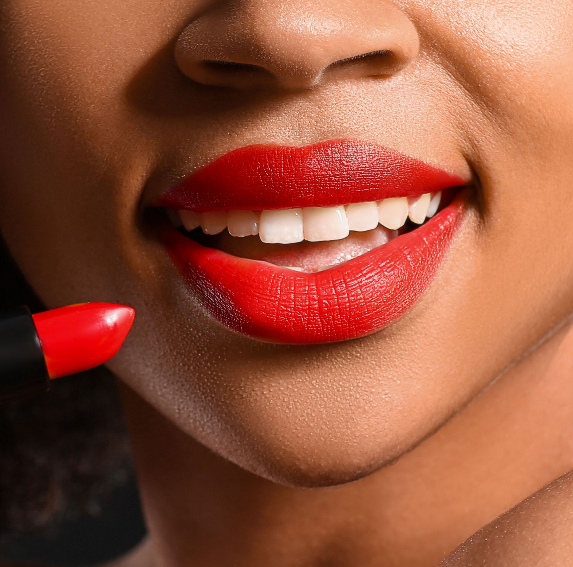 Lipstick is applied to a person’s lips. 