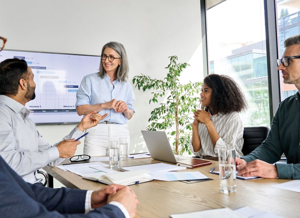 Employees in an office going over collaboration strategy. 