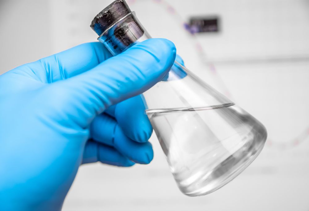 A capped conical flask filled with clear liquid. 