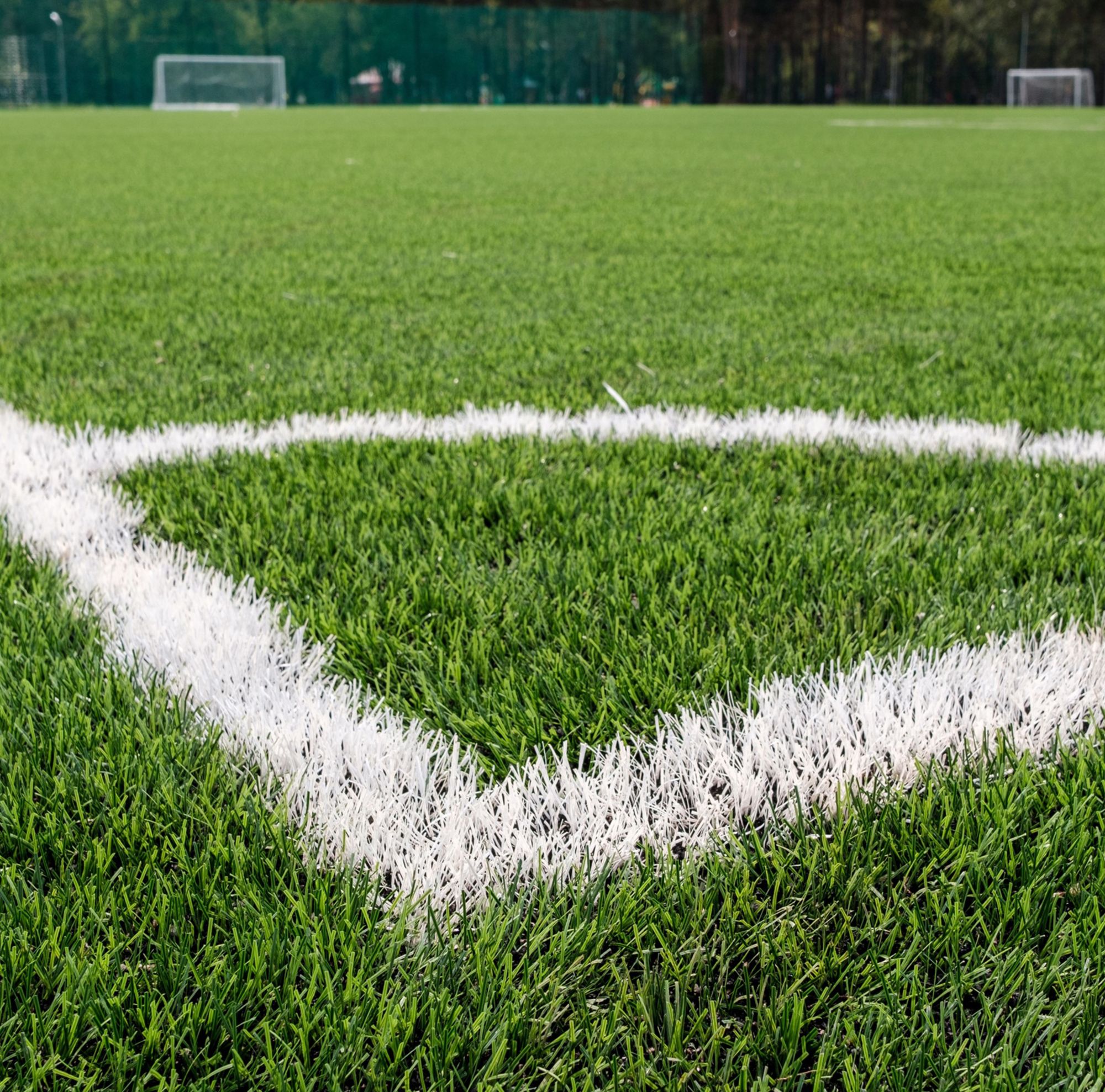 Corner view of football field made of artificial turf. 