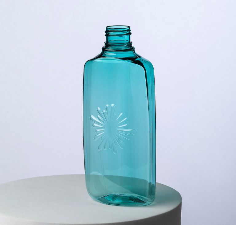 Clear light blue bottle made from Eastman recycled‑content PET, designed for cosmetic packaging.  
