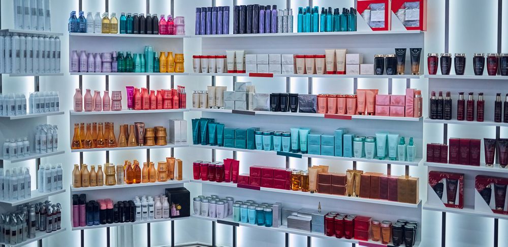 Cosmetic bottles and boxes line store shelves.  