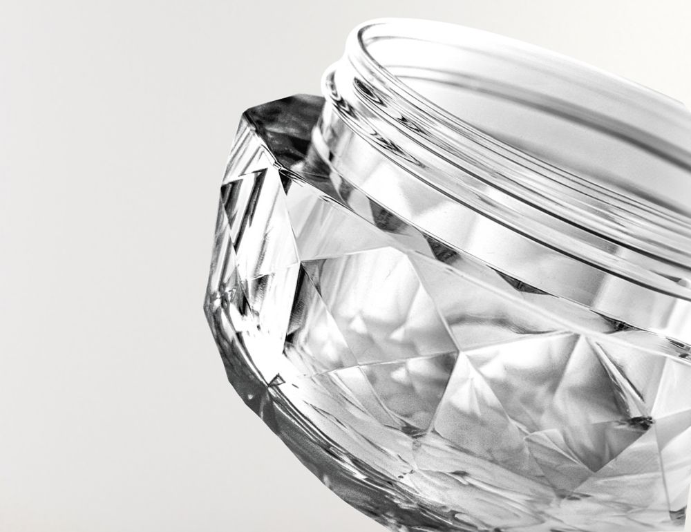 Close-up of a clear, open and thick cosmetic jar made from Eastman Cristal resin.  