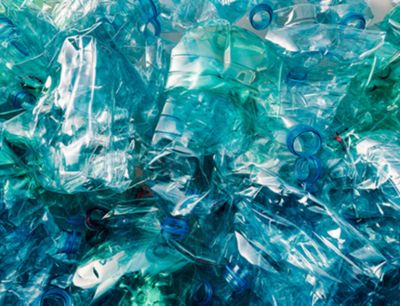 A pile of blue/green plastic bottles. 