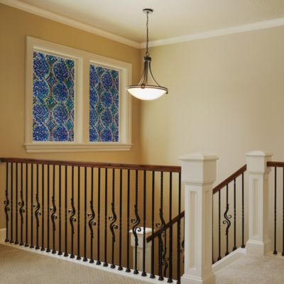 Interior view of Gila® Pinwheel Decorative Window Film on windows over stairs