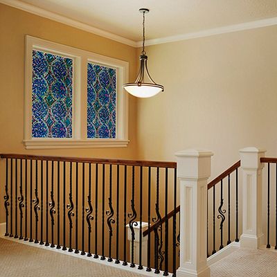 Interior view of Gila® Spiral Mosaic Decorative Window Film on windows over stairs