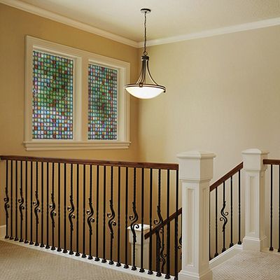 Interior view of Gila® Stained Glass Atlantis Decorative Window Film on windows over stairs