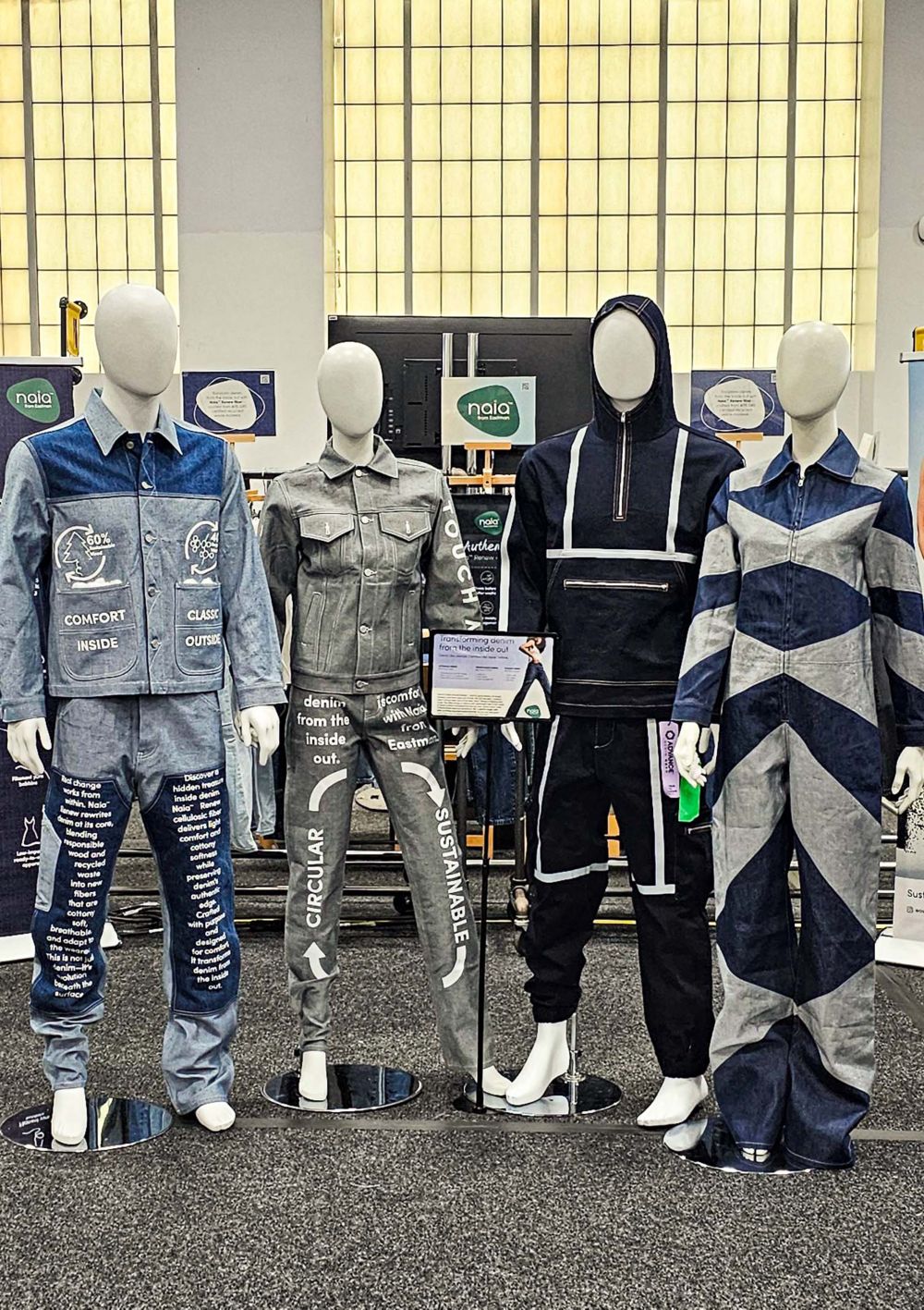 Four mannequins dressed in all-denim styles made with Naia. 