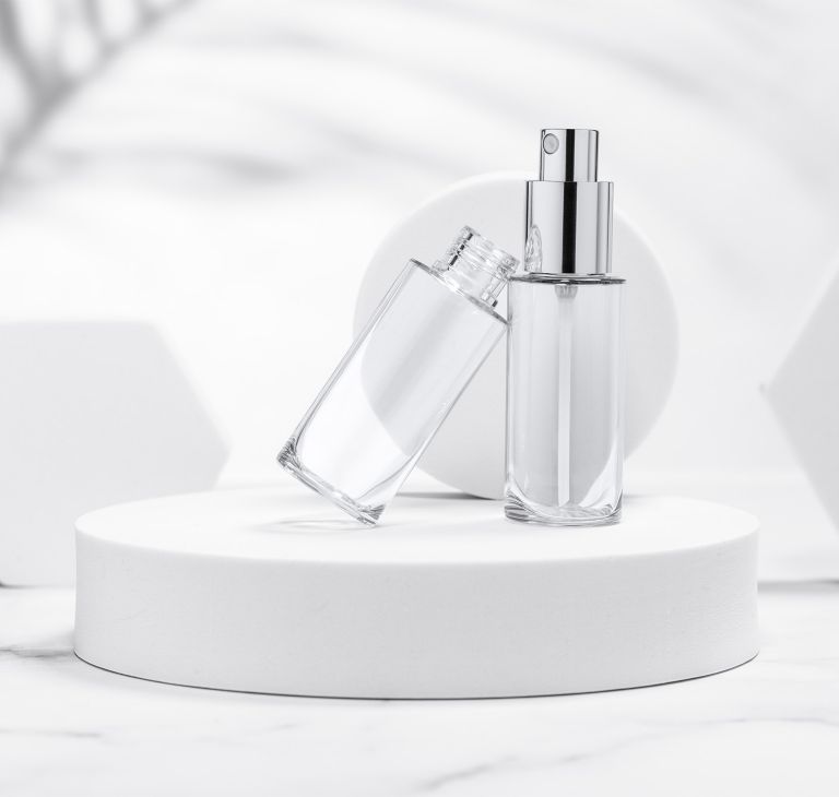 Two empty and clear cosmetic bottles made from Eastman Tritan copolyester.  