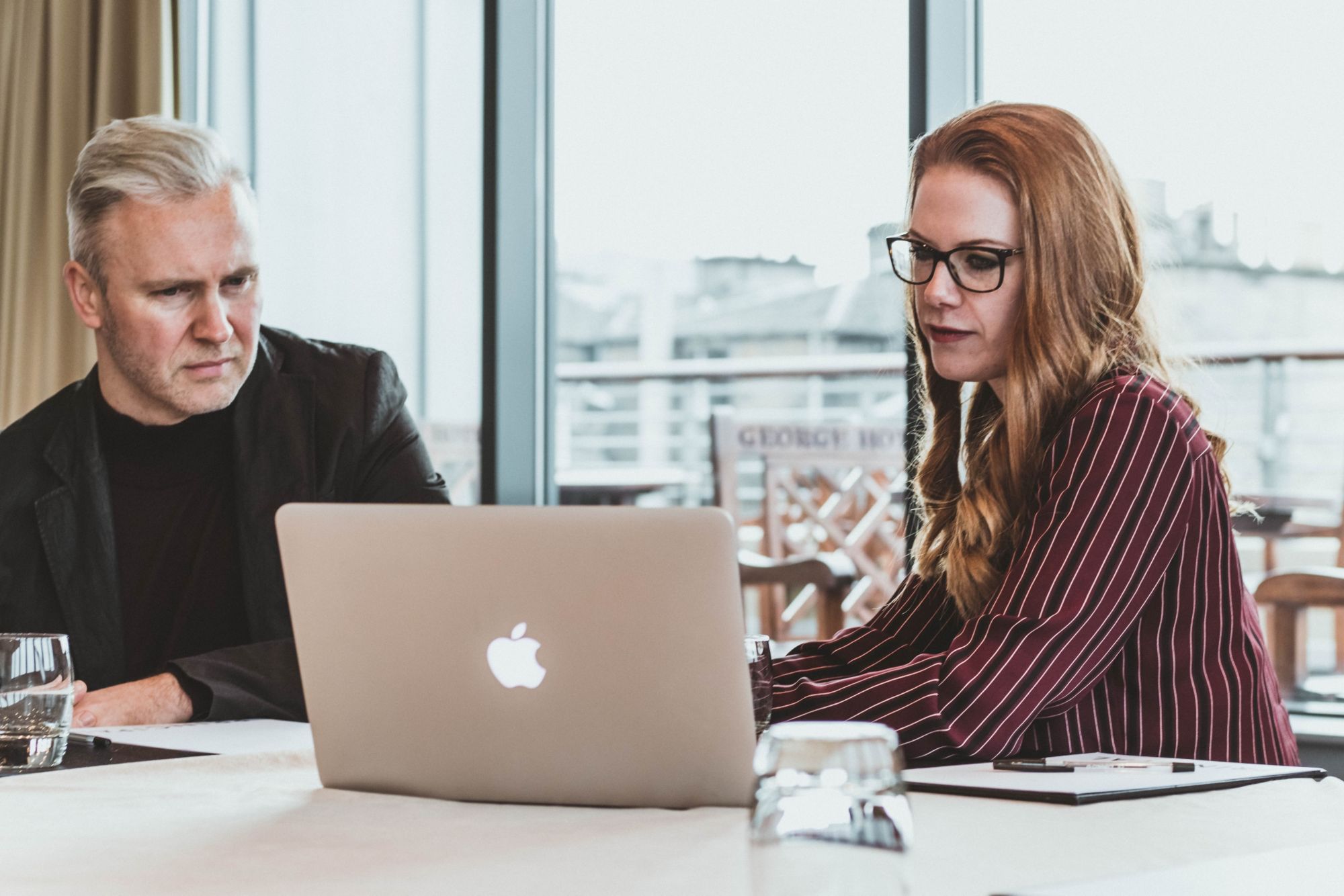 men and women looking at the laptop screen 