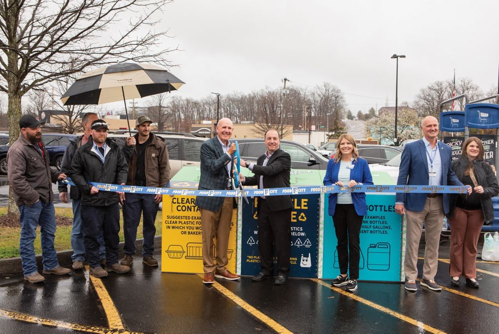 Food City and Eastman employees cut the ribbon to open new recycling bins in a Food City parking lot in Kingsport, Tennessee 