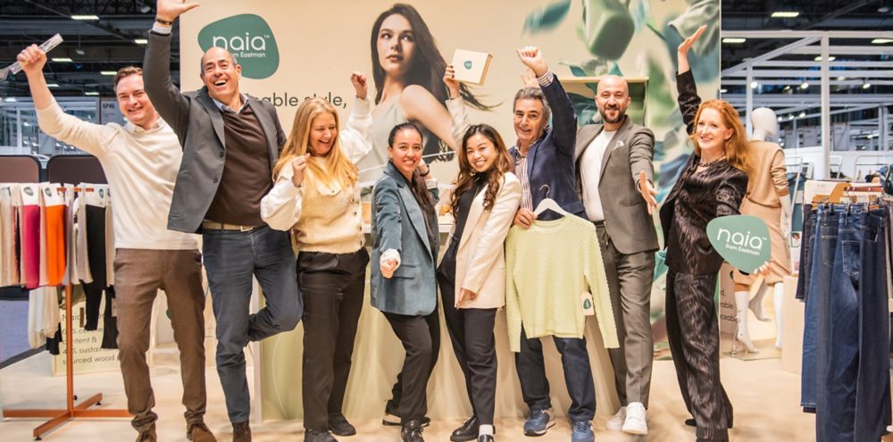 Eight Eastman representatives pose at the Naia booth during Première Vision Paris.  