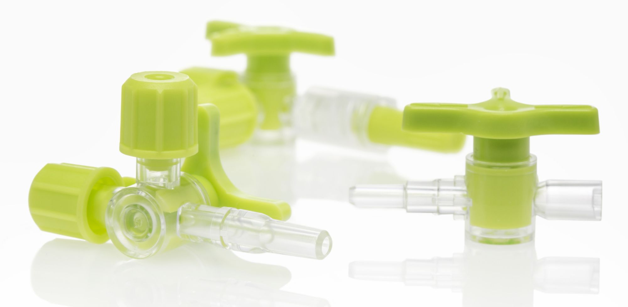 Three bright green stopcock valves. 