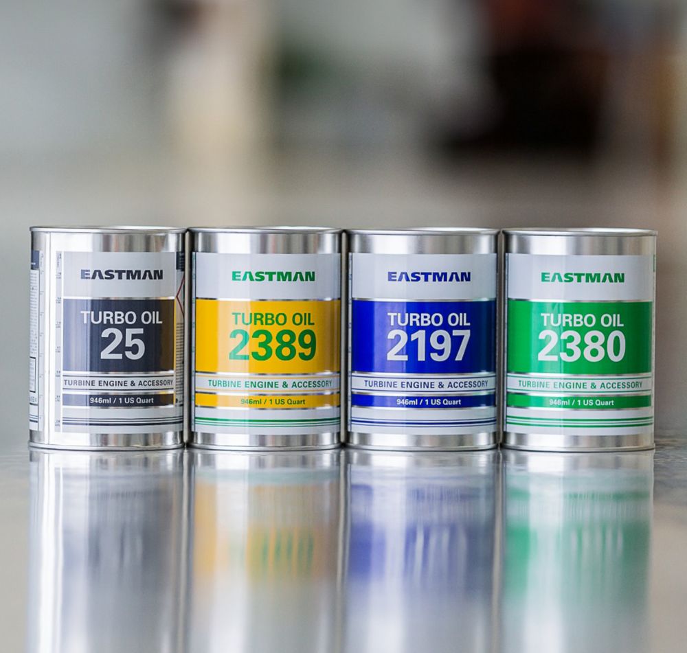 Four cans of Eastman turbo oil sit in a row. 