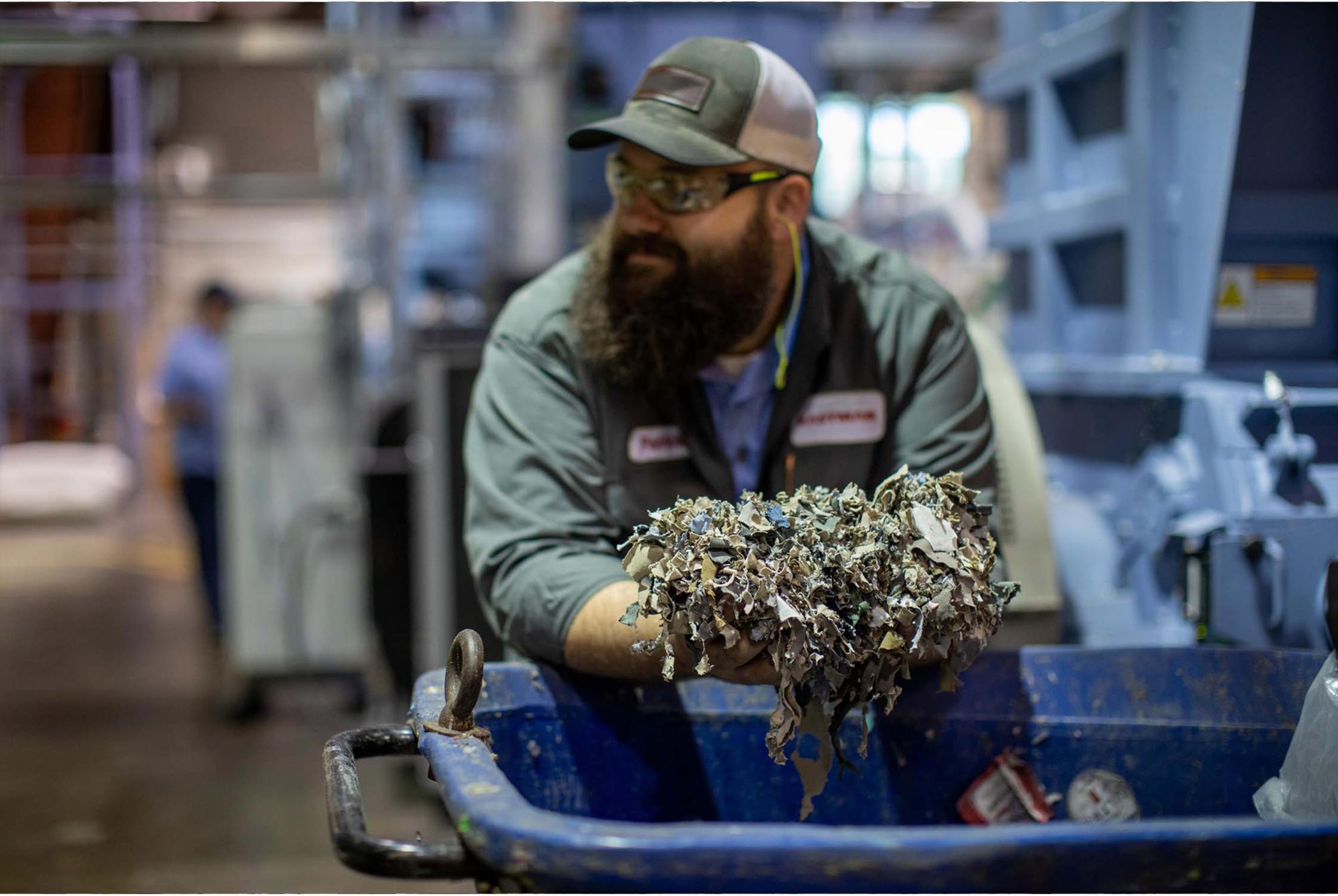 An Eastman employee holds shredded apparel waste 