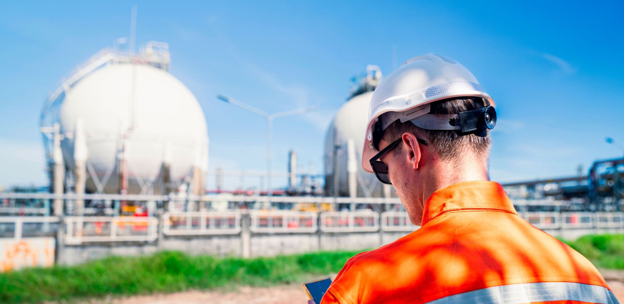 An engineer in PPE performs a site inspection. 
