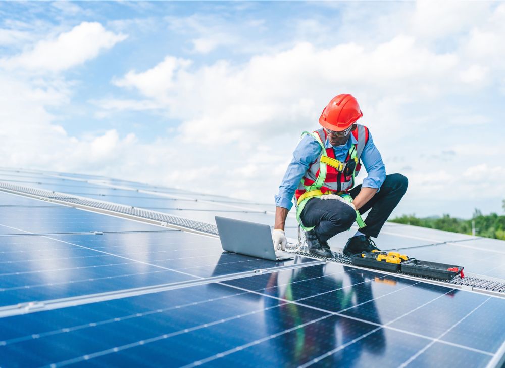 An engineer installs a solar panel.  