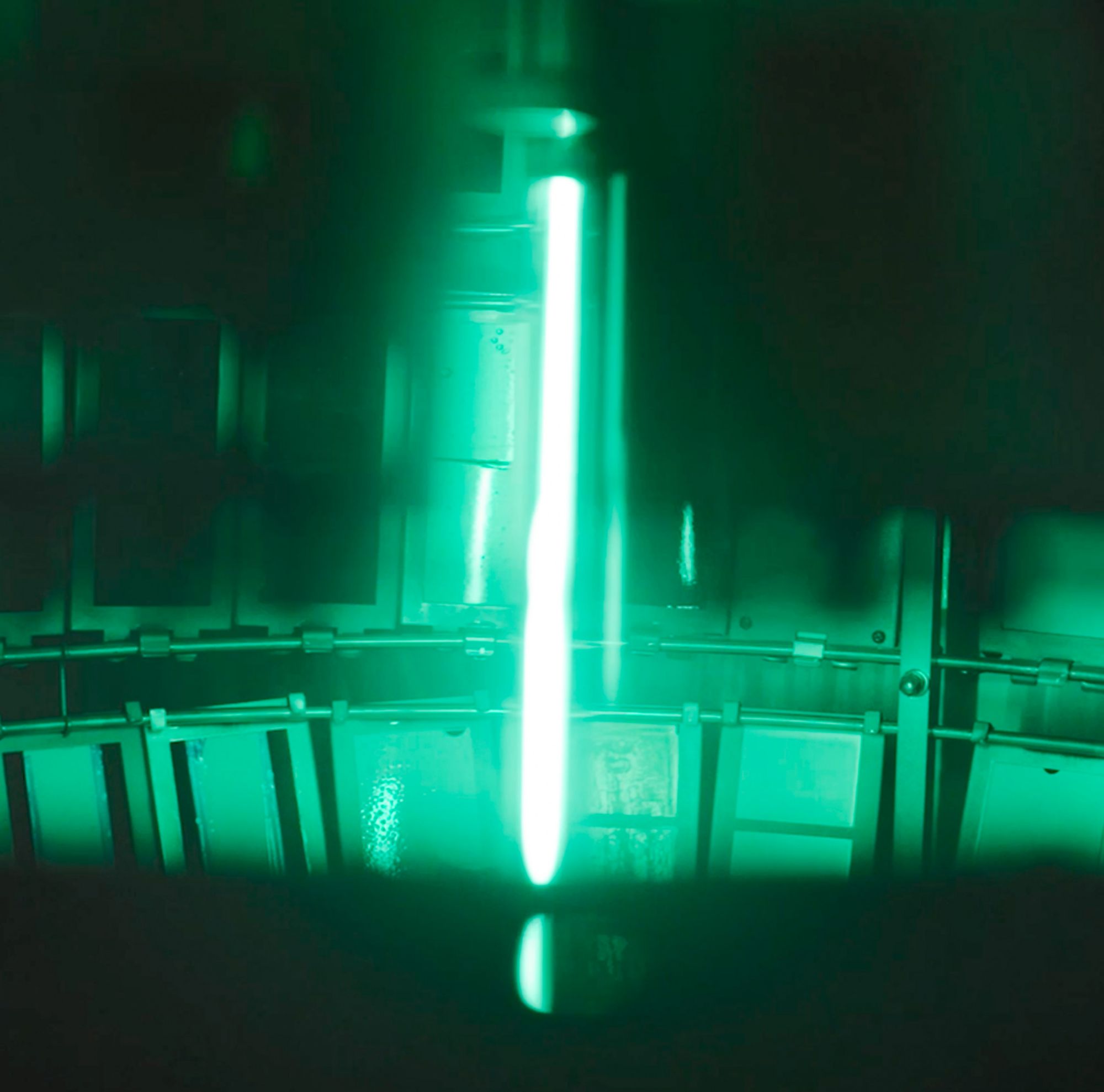 A weathering testing device featuring a central green light source surrounded by various plastic sheets. 