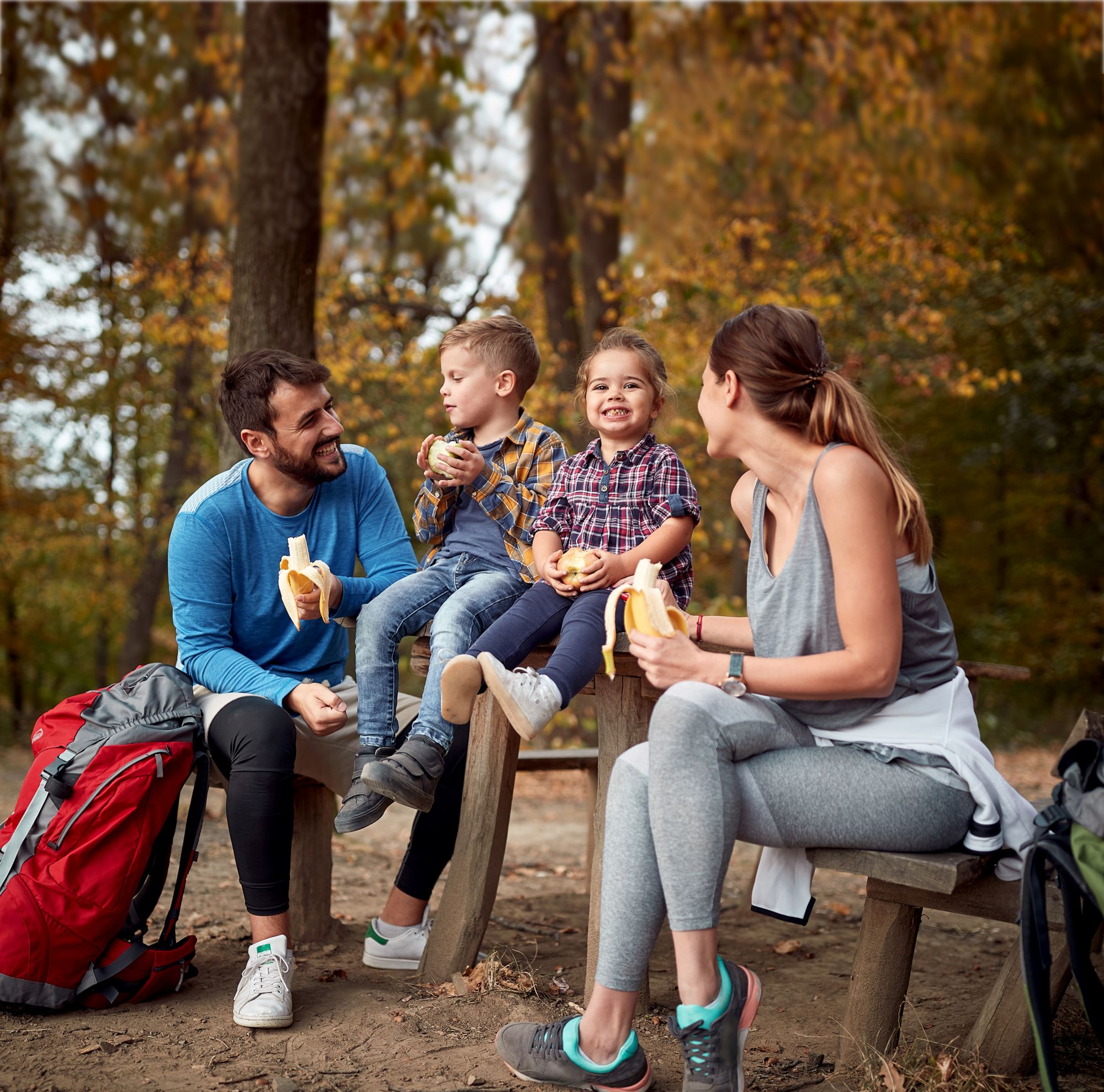 Family taking break hiking. 