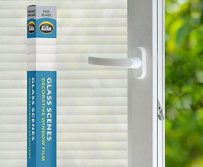 Retail packaging displayed next to a window treated with the Faux Blinds decorative film.