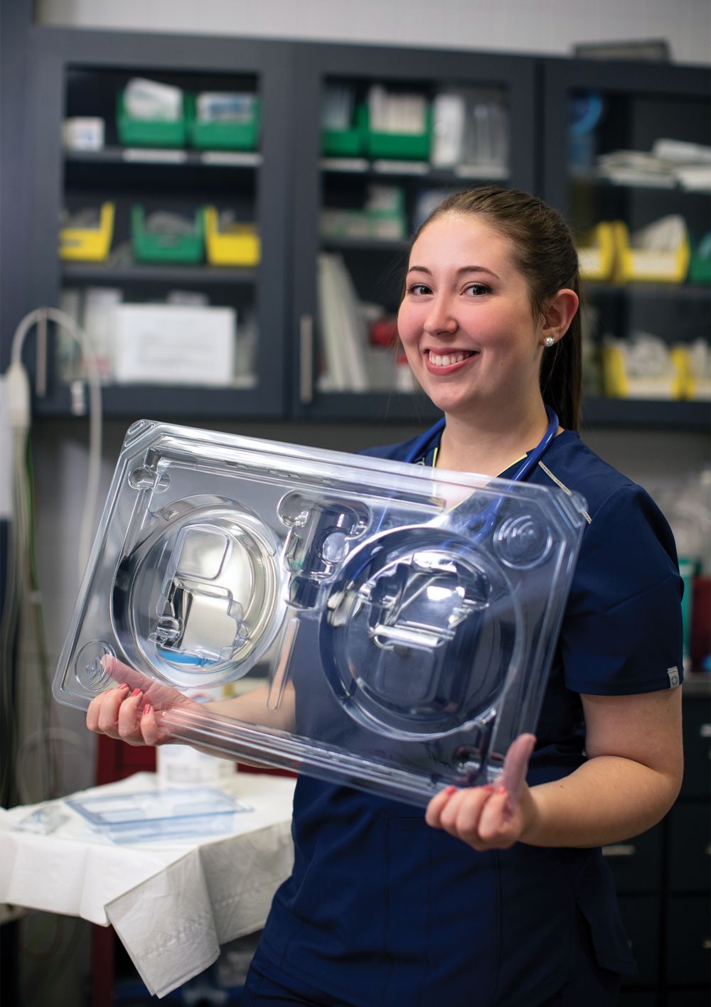 A female doctor holds a piece of clear medical packaging made with Eastman Eastar Renew copolyester.  