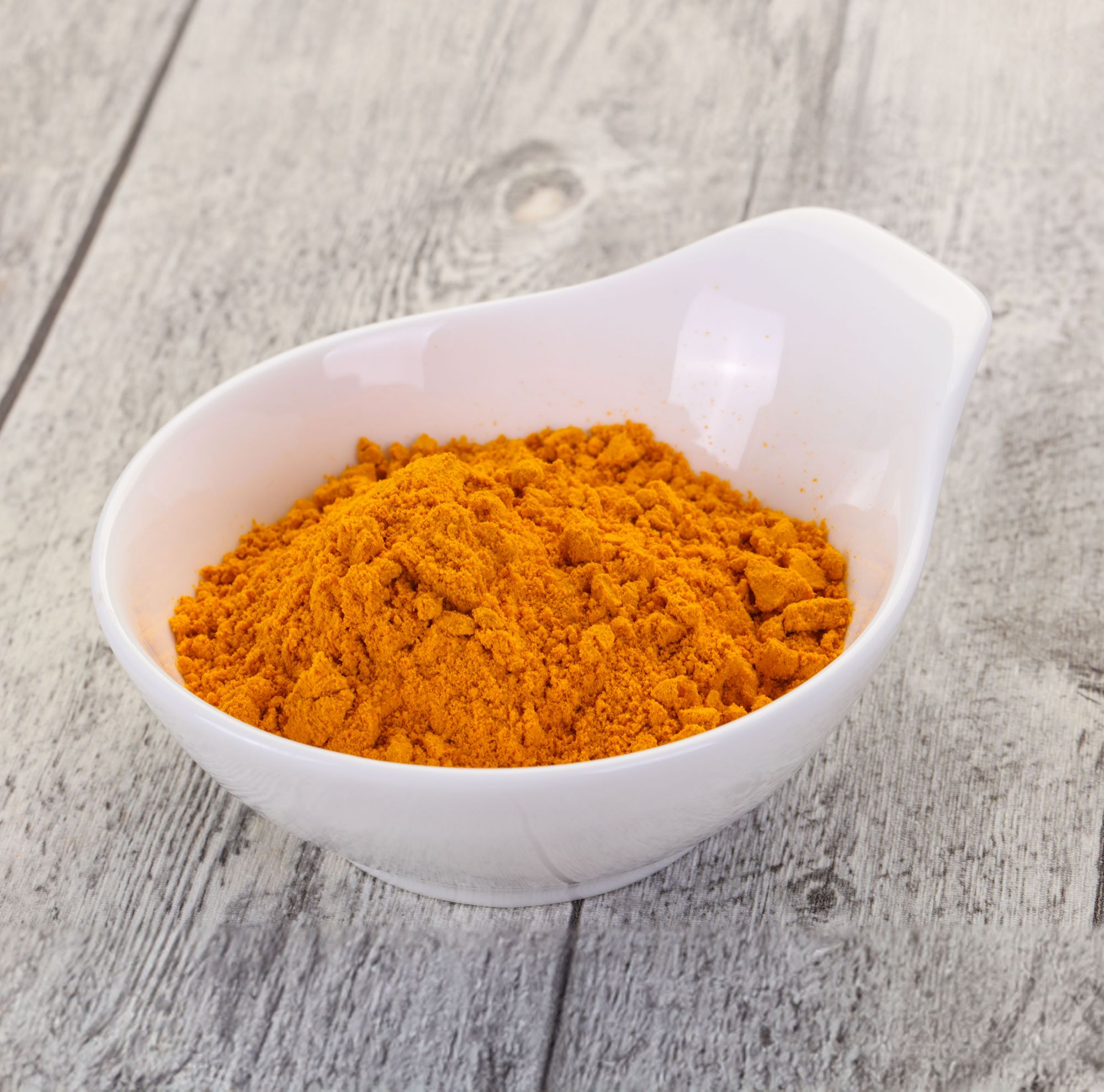 A cup of orange-colored flavoring powder. 